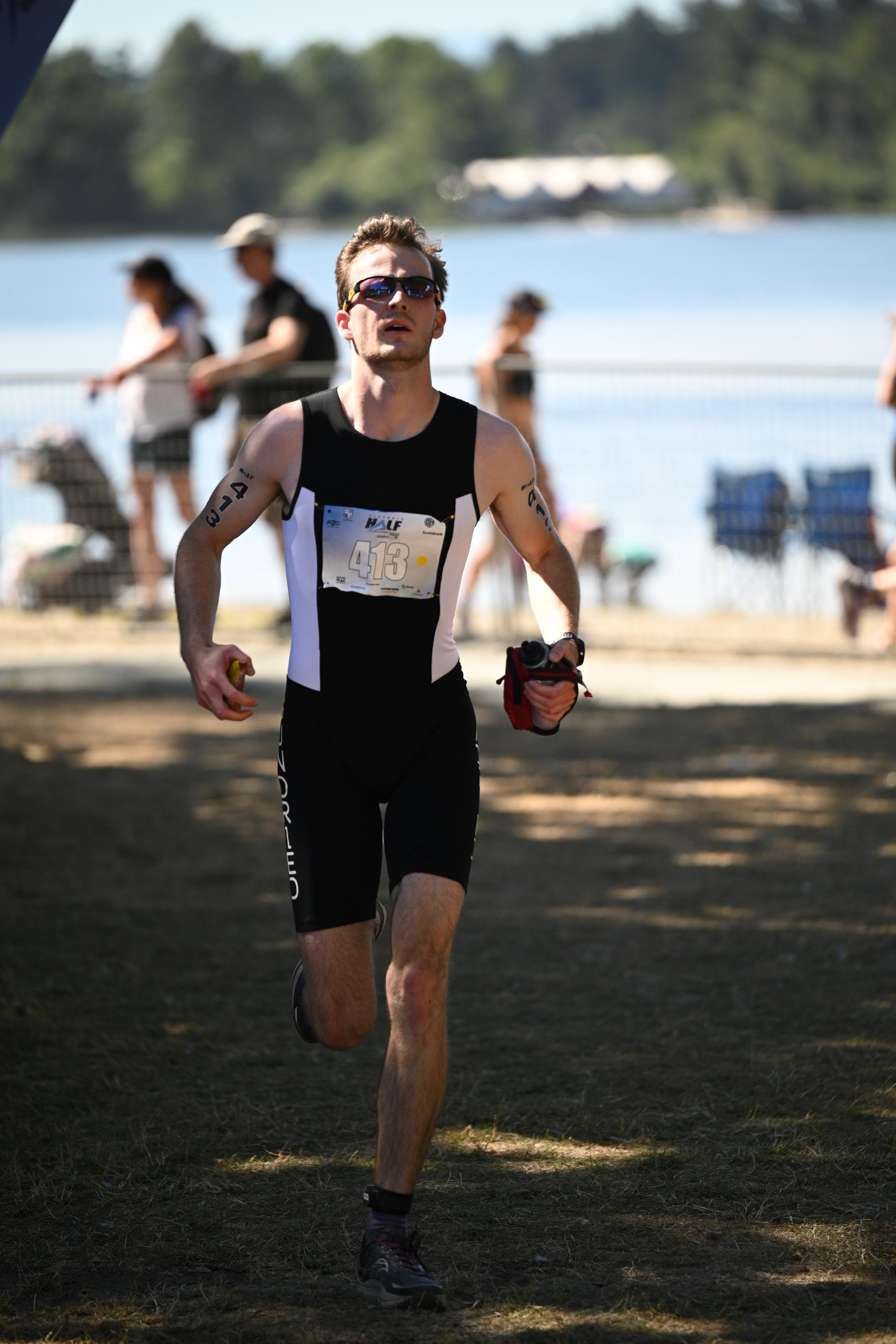 Lucas Gage crossing the finish at Elk Lake Duathlon
